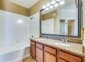 Thumbnail 28 of 30 - a bathroom with a large mirror and two sinks