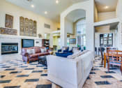 Thumbnail 27 of 30 - a living room with couches and chairs and a fireplace