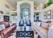 Thumbnail 20 of 30 - a living room with couches and a coffee table