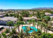 Thumbnail 17 of 30 - an aerial view of a swimming pool with palm trees     and houses