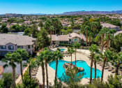 Thumbnail 8 of 30 - an aerial view of a swimming pool with palm trees and houses