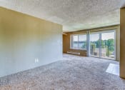 Thumbnail 17 of 17 - an empty living room with a balcony and a large window