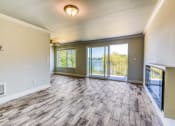 Thumbnail 13 of 17 - an empty living room with sliding glass doors to a balcony