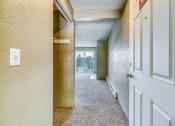 Thumbnail 16 of 17 - an empty hallway with a white door and a window