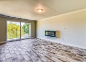 Thumbnail 11 of 17 - an empty living room with a fireplace and a sliding glass door