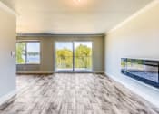 Thumbnail 10 of 17 - an empty living room with sliding glass doors and a view of the lake