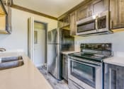 Thumbnail 7 of 17 - a kitchen with stainless steel appliances and a sink
