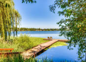 Thumbnail 5 of 17 - a dock on a lake near a weeping willow tree