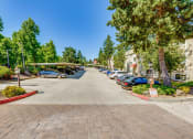 Thumbnail 2 of 17 - a parking lot with cars parked on the side of a street