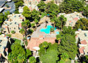 Thumbnail 24 of 32 - an aerial view of a house with a pool in the middle of a neighborhood at Pacific Harbors Sunrise Apartments, Las Vegas, NV, 89142
