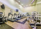 Thumbnail 34 of 43 - a gym with treadmills and other exercise equipment