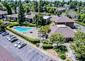Thumbnail 29 of 43 - an aerial view of a home with a swimming pool and parking lot