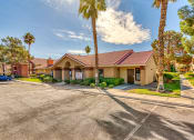 Thumbnail 21 of 39 - a building with a parking lot and palm trees