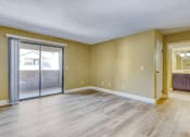 Thumbnail 17 of 39 - an empty living room with a sliding glass door to a patio