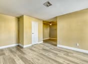 Thumbnail 32 of 39 - the living room and dining room of an empty house with wood floors