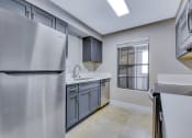 Thumbnail 28 of 39 - a renovated kitchen with stainless steel appliances and a window