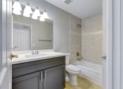 Thumbnail 22 of 39 - a bathroom with a sink toilet and a tub