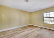 Thumbnail 25 of 39 - an empty attic with a wooden floor and a window