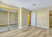 Thumbnail 34 of 39 - the living room of an empty apartment with wood floors and a door to the hallway