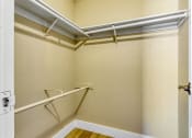 Thumbnail 35 of 39 - a walk in closet with white walls and a white door
