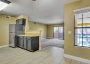 Thumbnail 19 of 39 - an empty kitchen and living room with a refrigerator