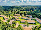 Thumbnail 6 of 25 - A bird's eye view of a residential area with houses and trees.