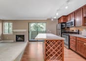 Thumbnail 2 of 21 - Kitchen and Living Room at Whispering Brook Apartments, Des Moines,98198
