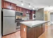 Thumbnail 6 of 21 - Kitchen Island and Kitchen at Whispering Brook Apartments, Washington