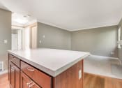 Thumbnail 7 of 21 - Kitchen Island Facing Living Room at Whispering Brook Apartments, Des Moines