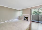 Thumbnail 8 of 21 - Fireplace and Outdoor Patio at Whispering Brook Apartments, Des Moines, Washington
