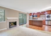 Thumbnail 9 of 21 - Living Room with Fireplace at Whispering Brook Apartments, Des Moines,98198