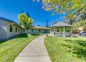 Thumbnail 8 of 13 - A white building with a gazebo in front of it.