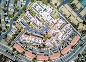 Thumbnail 22 of 28 - an aerial view of a building surrounded by streets and cars