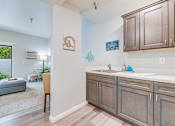 Thumbnail 7 of 28 - A kitchen with a sink and cabinets.