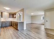 Thumbnail 1 of 28 - A spacious kitchen with wooden floors and a large island.