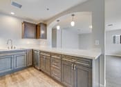 Thumbnail 4 of 28 - A kitchen with wooden cabinets and a white countertop.