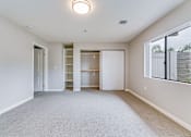Thumbnail 10 of 28 - A spacious room with a carpeted floor and a ceiling light.