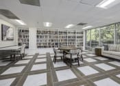 Thumbnail 16 of 23 - a room with a library and a table and chairs