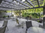 Thumbnail 15 of 23 - a patio with tables and chairs and a pergola