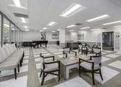 Thumbnail 18 of 23 - a conference room with tables and chairs and a piano