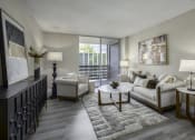 Thumbnail 7 of 23 - an open living room with a couch and chairs and a table