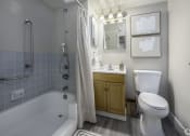 Thumbnail 10 of 23 - a bathroom with a toilet and a tub and a sink