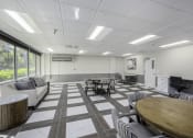 Thumbnail 17 of 23 - a conference room with tables and chairs and a projector screen