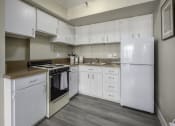 Thumbnail 5 of 23 - a kitchen with white cabinets and appliances and a white refrigerator