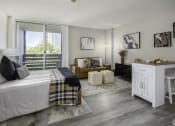 Thumbnail 2 of 23 - a bedroom with a bed and a large window