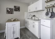 Thumbnail 4 of 23 - a kitchen with white cabinets and stainless steel appliances and a white refrigerator
