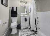 Thumbnail 11 of 23 - a white bathroom with a white toilet and a shower