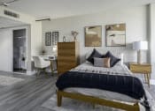 Thumbnail 8 of 23 - a bedroom with a bed and a desk with a chair