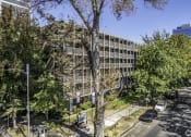 Thumbnail 1 of 23 - an office building with trees in front of it