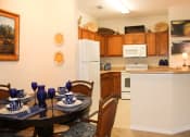 Thumbnail 2 of 17 - Fully Equipped Dining Area at Villa Valencia Apartments, in rlando Florida